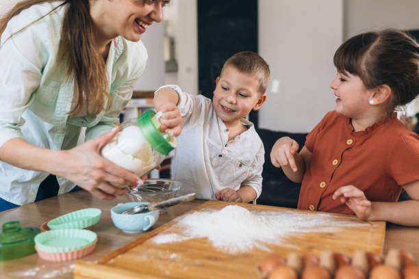 istock children baking with their mother at home 1303617430