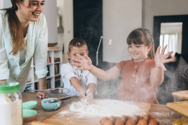 istock children baking with their mother at home 1303617511