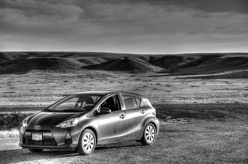 car parked in dramatic grassland landscape, Grasslands National Park, Saskatchewan