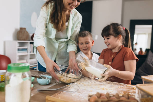 istock children baking with their mother at home 1303618216