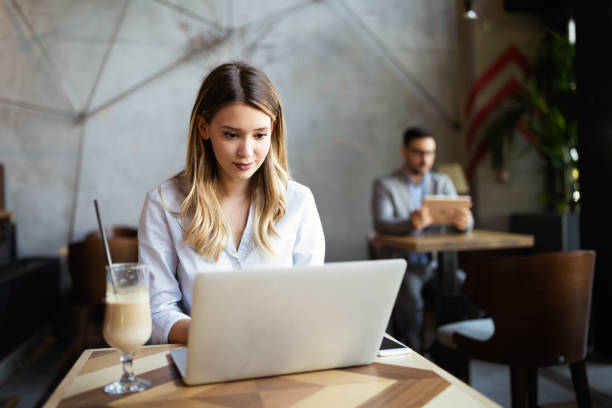 istock Happy young beautiful woman working, surfing, studying on laptop 1303619309