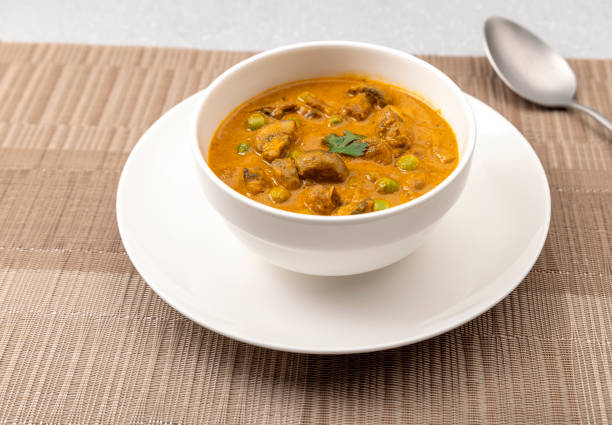 istock creamy peas and mushroom curry in a white bowl 1303619568