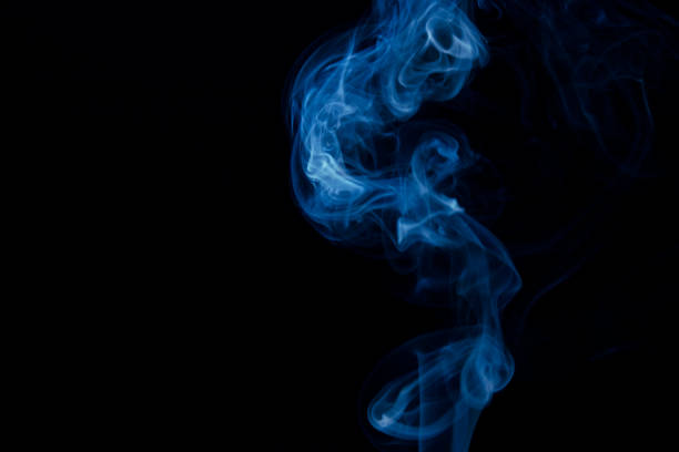 istock Colored fumes on black background 1303619966