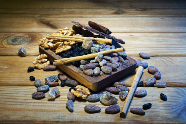 istock Cocoa beans, cinnamon, raisins, caramel sugar, chocolate, nuts on a wooden table. 1303619972