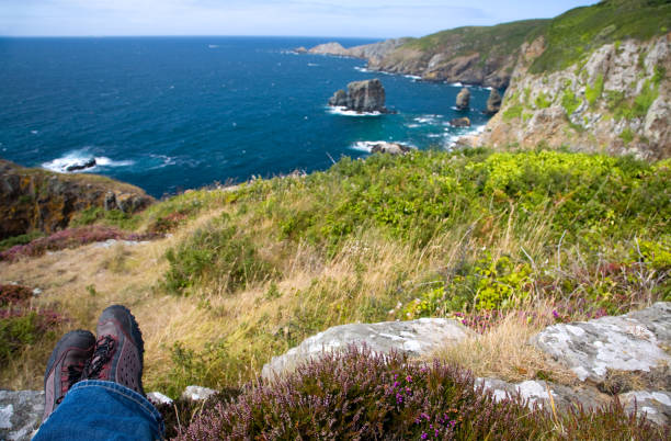 istock man looking out on rugged coast after hike on Sark, Channel Islands 1303621323