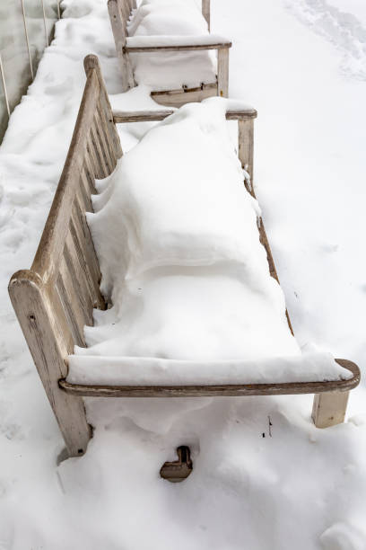 istock The bench in the winter park is covered with snow 1303622273