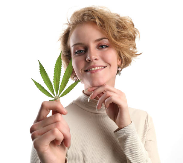 istock Healthy Young woman holding hemp leaf 1303625229