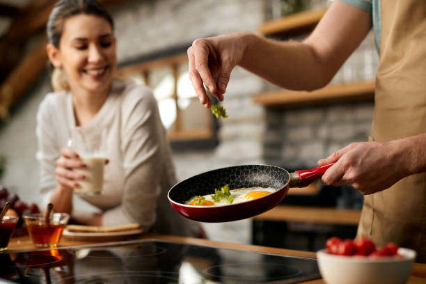 istock Close-up of man preparing breakfast for his girlfriend n the kitchen. 1303625249