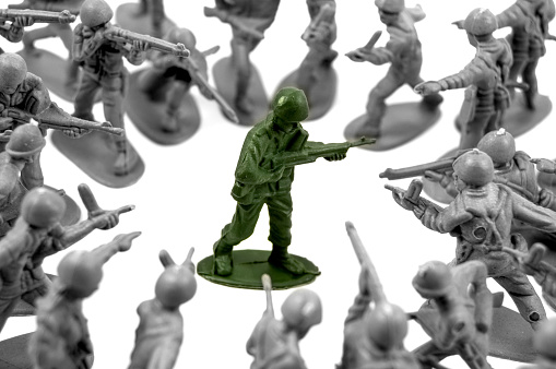 toy green army man surrounded