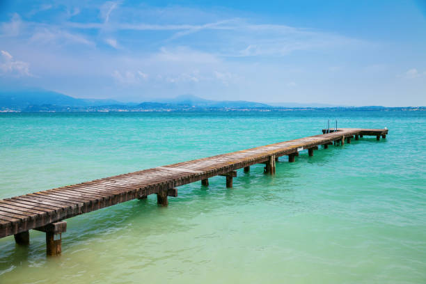 istock pier at the lake Garda 1303628212
