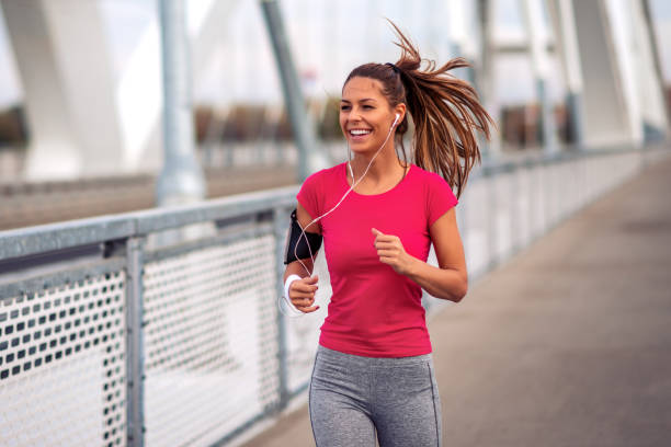 istock Fitness woman jogging outdoors on bridge 1303628222