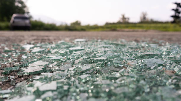 istock broken car window glass on the ground at a parking lot 1303629084