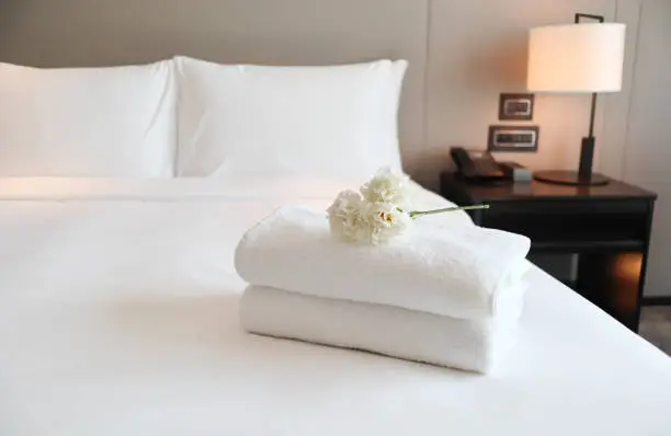 Photo of Clean white bath towels on the neatly clean bedroom - coziness and clean concept