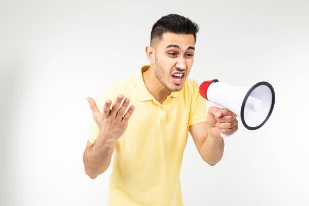 istock portrait of a young man with a loudspeaker in his hands on a white studio background 1303630954