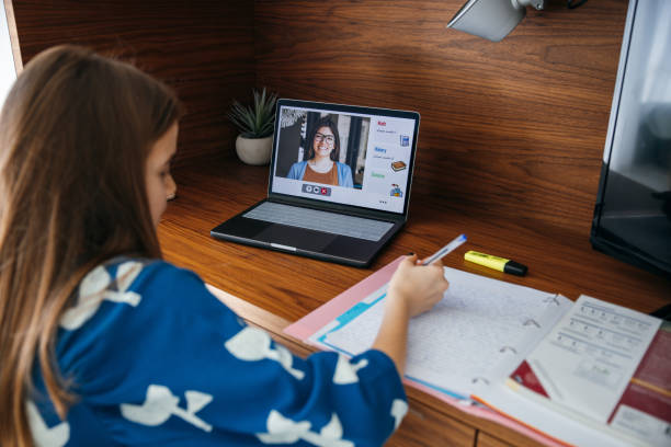 istock Girl studying at home, online with her teacher using homeschooling platform. 1303633334