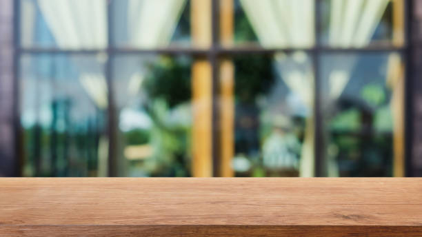 istock Empty wood table top and blurred coffee shop and restaurant interior background - can used for display or montage your products. 1303633735