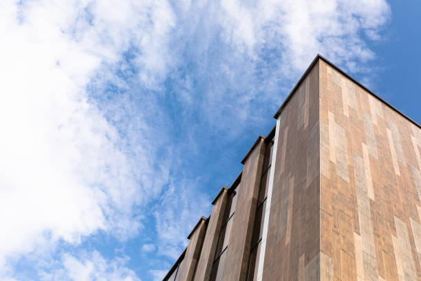 istock A large and tall gray house against the sky 1303634198