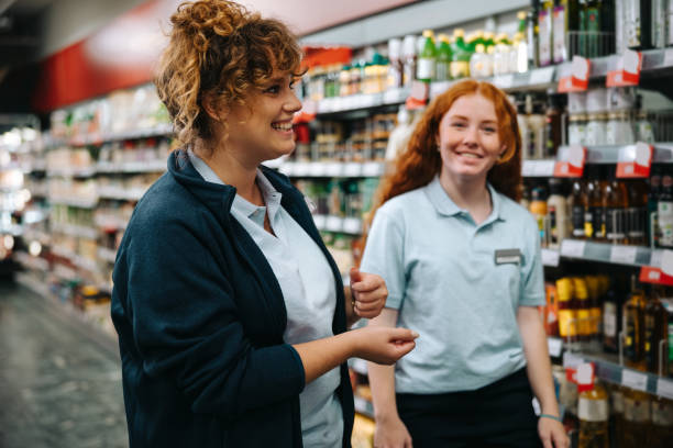 istock Supermarket manager training young woman worker 1303634542