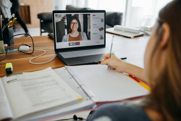 istock Girl studying at home, online with her teacher using homeschooling platform. 1303634589