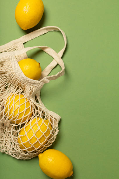 istock Lemons in an eco-friendly bag on a green background 1303635988