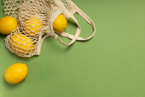 istock Lemons in an eco-friendly bag on a green background 1303636003