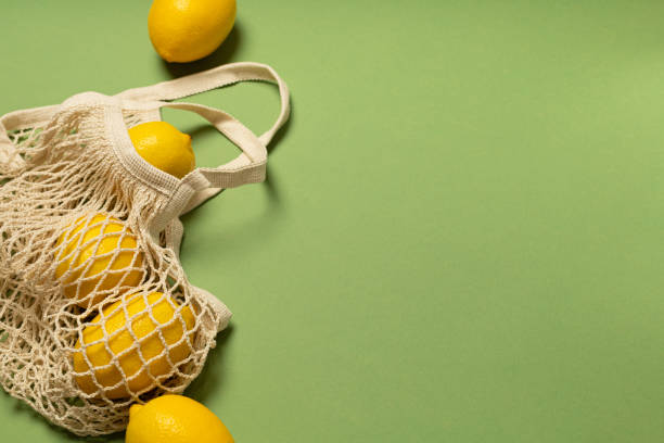 istock Lemons in an eco-friendly bag on a green background 1303636005