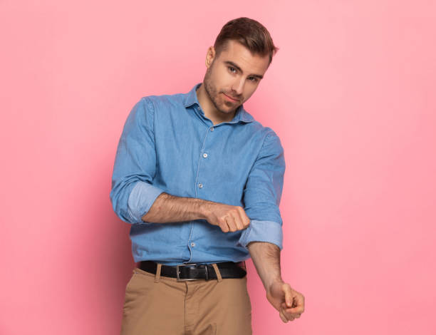istock attractive bearded guy in denim shirt arranging sleeve 1303636047