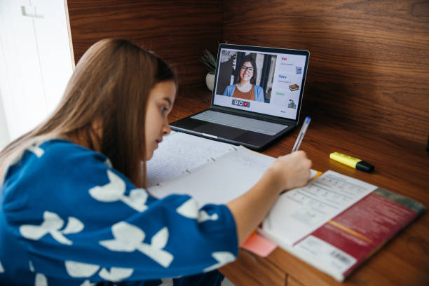 istock Girl studying at home, online with her teacher using homeschooling platform. 1303636058