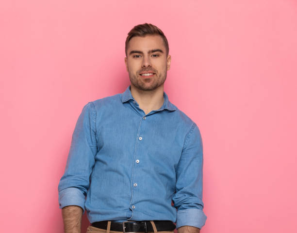 istock smiling young man in denim shirt smiling and posing 1303636071