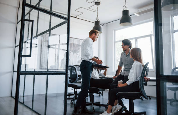 istock Active conversation. Young business people in formal clothes working in the office 1303638574