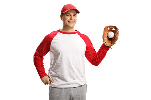 Smiling man catching a baseball ball with a glove isolated on white background