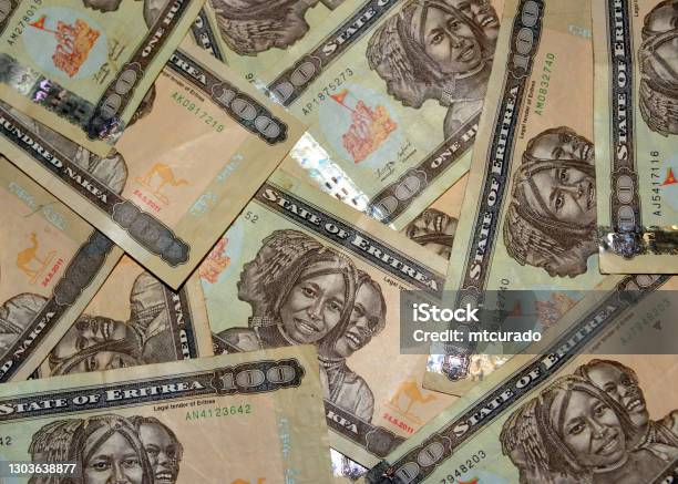 Eritrean Nakfa Bank Notes 100 Ern In Random Arrangement Stock Photo - Download Image Now
