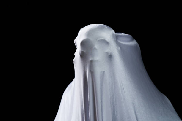 istock White ghost in white cloth on isolated black background. Face devil shouting covered curtain on blank. Halloween concept. 1303640159