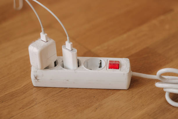 istock Dusty white extension cord at home. Dangerous inflammation 1303641906
