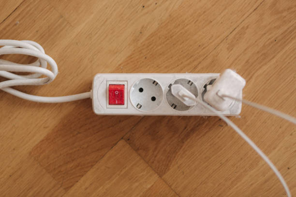 istock Dusty white extension cord at home. Dangerous inflammation. Top view 1303641914