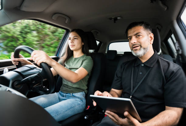 Driver training exam. Young girl taking lessons for driving on the road in Auckland, New Zealand. driving licence stock pictures, royalty-free photos & images