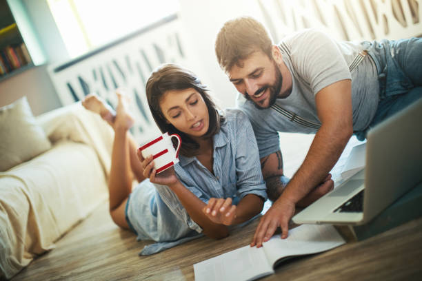 istock Young couple looking at decoration brochures. 1303643518