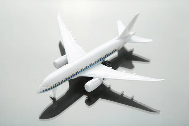 istock Creative composition made with passenger plane on black background. Summer travel or vacation concept. 1303643894