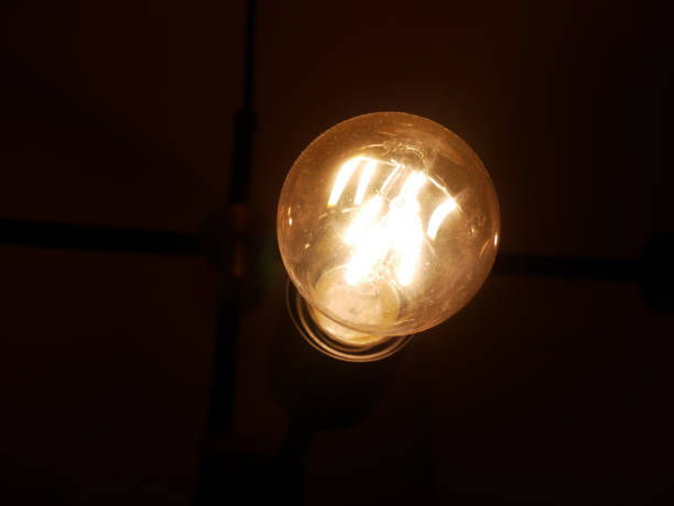 istock Modern lamp flickers in a loft-style interior. Beautiful design idea. 1303643998