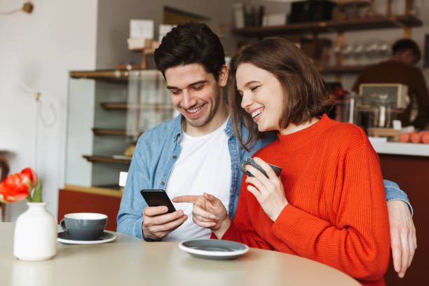 istock Happy young couple sitting at the cafe table 1303645226
