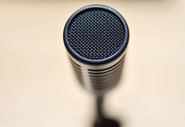 istock High angle view on the frontpart of a microphone, extremely selective focus and blurred background 1303645352