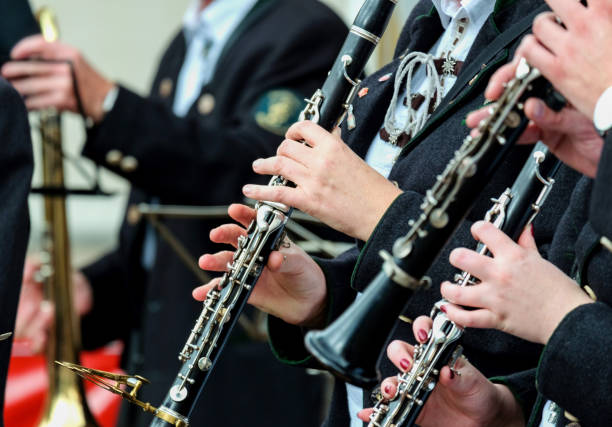 Close-up of a group of musicians in traditional clothing playing the clarinet at a festival Concept: music, concert, event, celebration, festival, fair or performance, selective focus clarinet stock pictures, royalty-free photos & images
