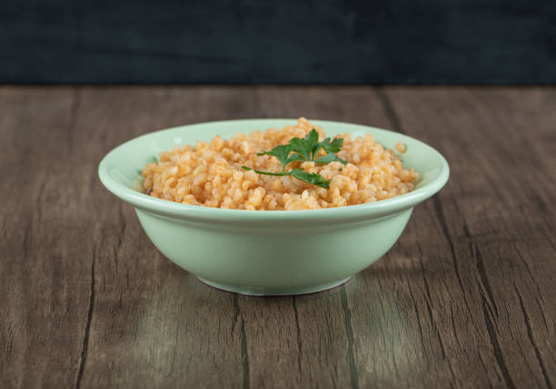 istock Delicious bulgur with greens on a green plate 1303646516