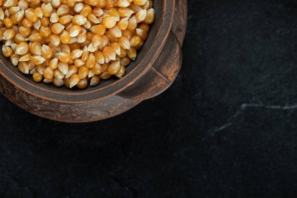 istock Pile of uncooked corn grains in ancient mug 1303648883