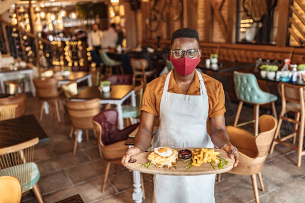 istock Waiter holding / showing a sandwich 1303649008