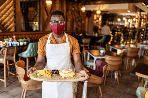 istock Business owner or waiter showing a hamburger 1303649034