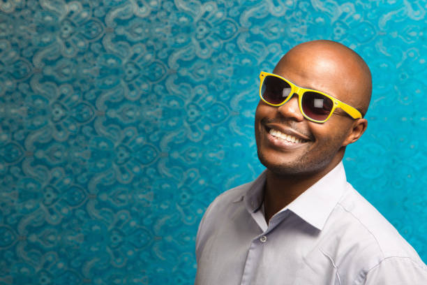 istock Handsome man in yellow sunglasses looks overjoyed 1303649934