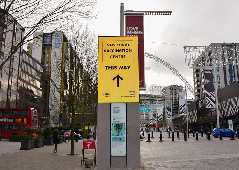 London, United Kingdom - January 21 2021: A direction sign for the NHS Covid-19 Vaccination Centre in Wembley.