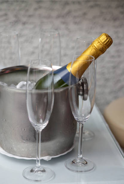 istock Wine bottle in ice bucket, Champagne flutes around 1303654828