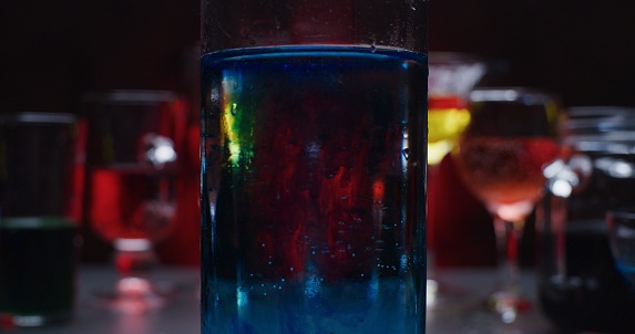 Drinks in various drinking glasses against the red and black background